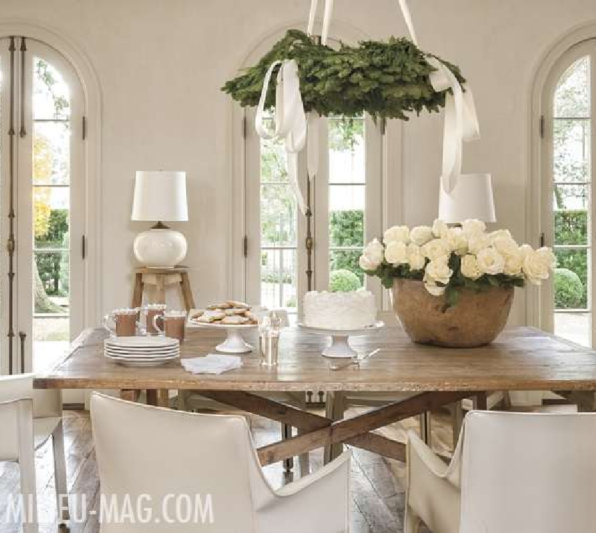 White Christmas decor in a modern French dining room with white roses and fresh greenery - Pamela Pierce for Milieu magazine. #christmasdecor #frenchcountry #elegantchristmasdecor