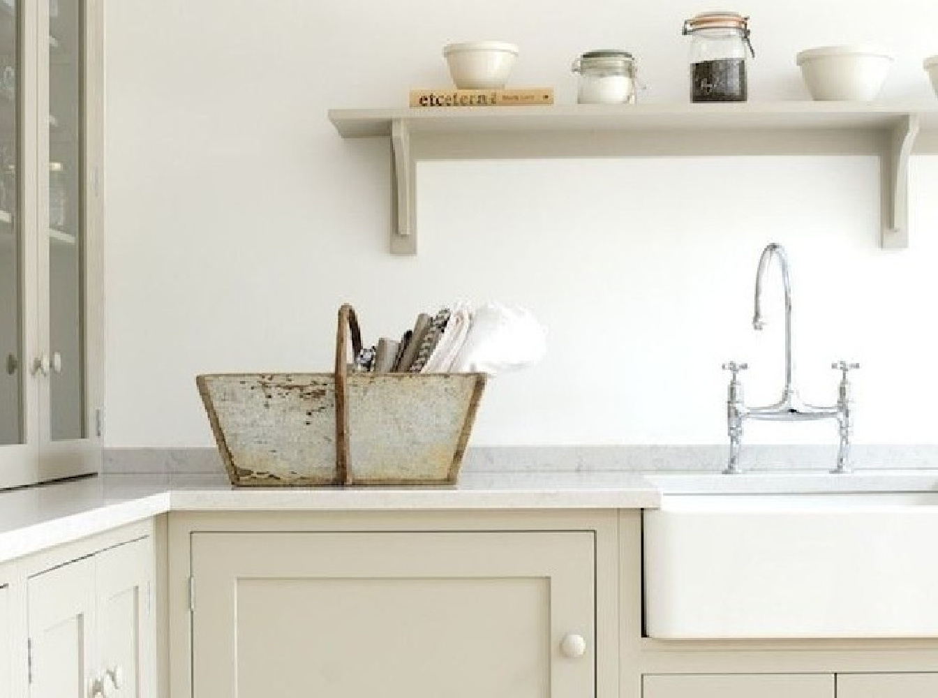 Gorgeous Shaker style kitchen by Devol with country style, Silestone Lagoon quartz counters, an open shelf, farm sink, and a chrome bridge faucet. #silestone #lagoon #quartz #kitchendesign