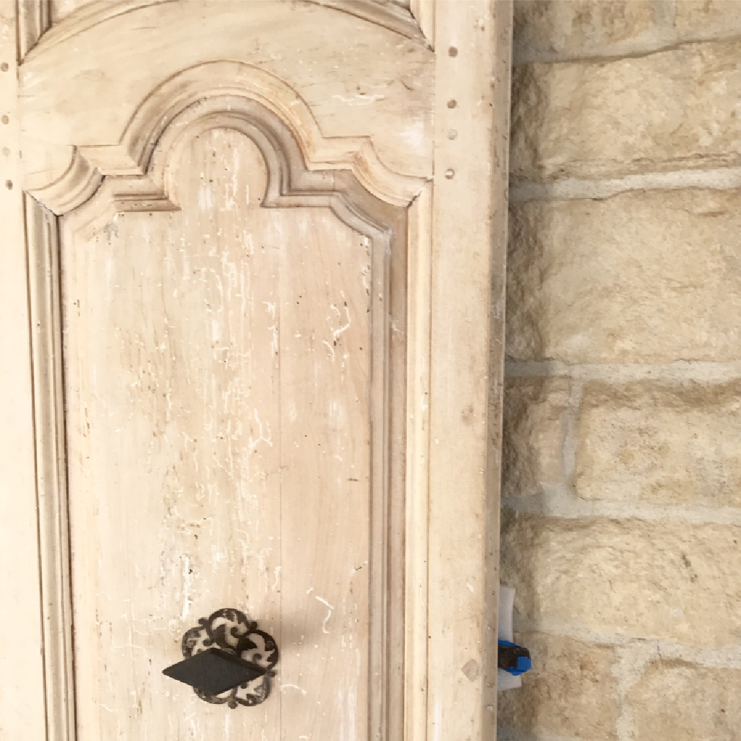 Detail of Chateau Domingue antique rustic door with limestone.