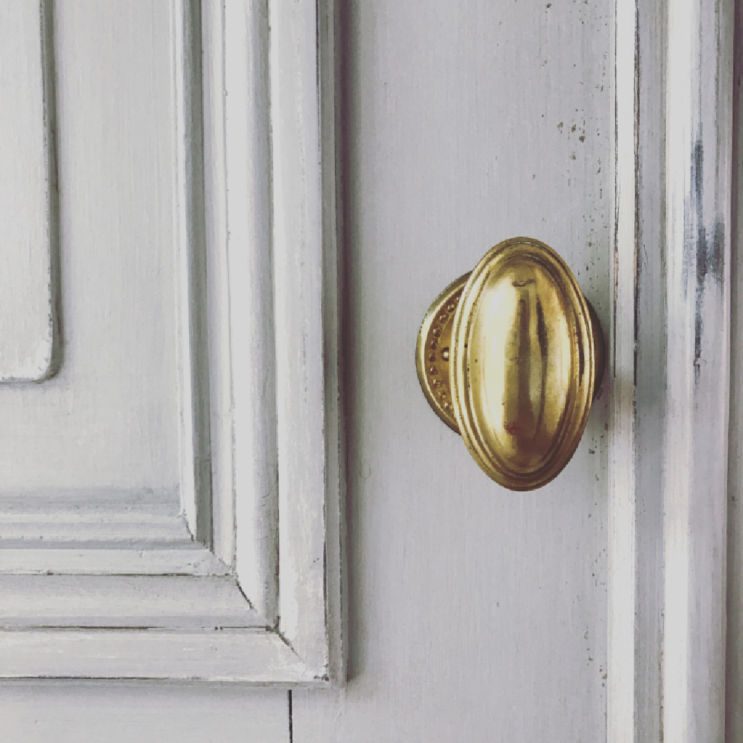 Detail of antique door with unlacquered brass oval knob. Steve Giannetti designed modern Mediterranean Malibu home with white oak, natural finishes, limestone, and Old World style. #giannettihome #patinastyle #patinahomes