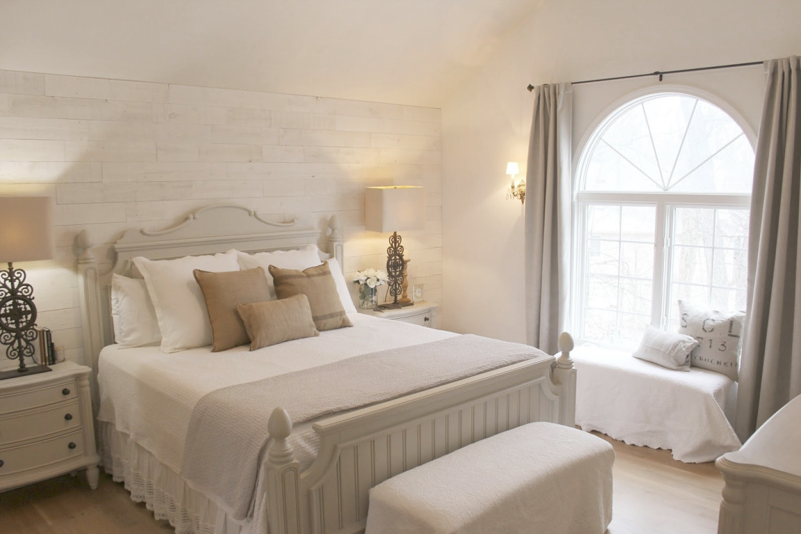 White French country cottage bedroom with Stikwood (hamptons) statement wall, white oak hardwood, and rustic alder doors. #hellolovelystudio #frenchcountry #bedroomdecor #rusticelegance #whiteoak #frenchbedrooms #alderdoor #stikwood #hamptons #romanticdecor #whitebedrooms #interiordesign