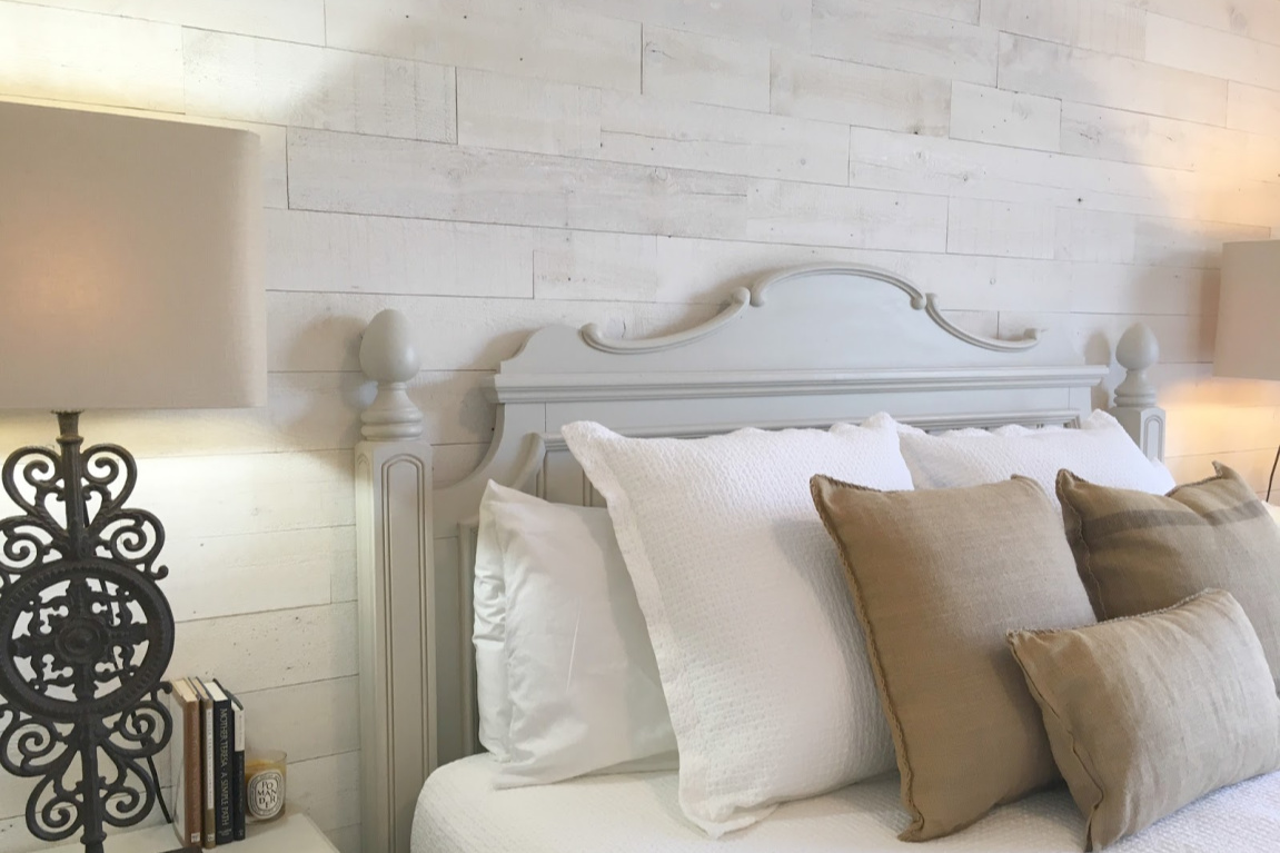 White French country cottage bedroom with Stikwood (hamptons) statement wall, white oak hardwood, and rustic alder doors. #hellolovelystudio #frenchcountry #bedroomdecor #rusticelegance #whiteoak #frenchbedrooms #alderdoor #stikwood #hamptons #romanticdecor #whitebedrooms #interiordesign