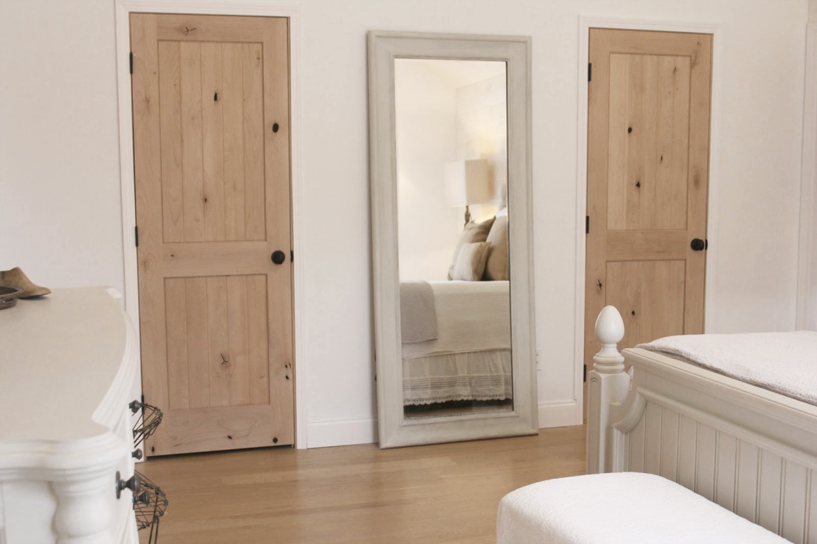 White French country cottage bedroom with Stikwood (hamptons) statement wall, white oak hardwood, and rustic alder doors. #hellolovelystudio #frenchcountry #bedroomdecor #rusticelegance #whiteoak #frenchbedrooms #alderdoor #stikwood #hamptons #romanticdecor #whitebedrooms #interiordesign