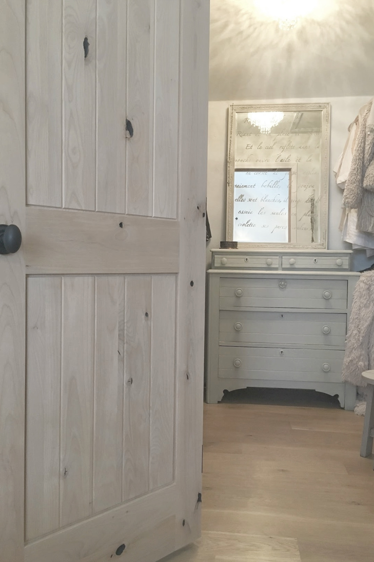 White French country cottage bedroom with Stikwood (hamptons) statement wall, white oak hardwood, and rustic alder doors. #hellolovelystudio #frenchcountry #bedroomdecor #rusticelegance #whiteoak #frenchbedrooms #alderdoor #stikwood #hamptons #romanticdecor #whitebedrooms #interiordesign