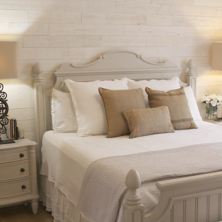 White French country cottage bedroom with Stikwood (hamptons) statement wall, white oak hardwood, and rustic alder doors. #hellolovelystudio #frenchcountry #bedroomdecor #rusticelegance #whiteoak #frenchbedrooms #alderdoor #stikwood #hamptons #romanticdecor #whitebedrooms #interiordesign