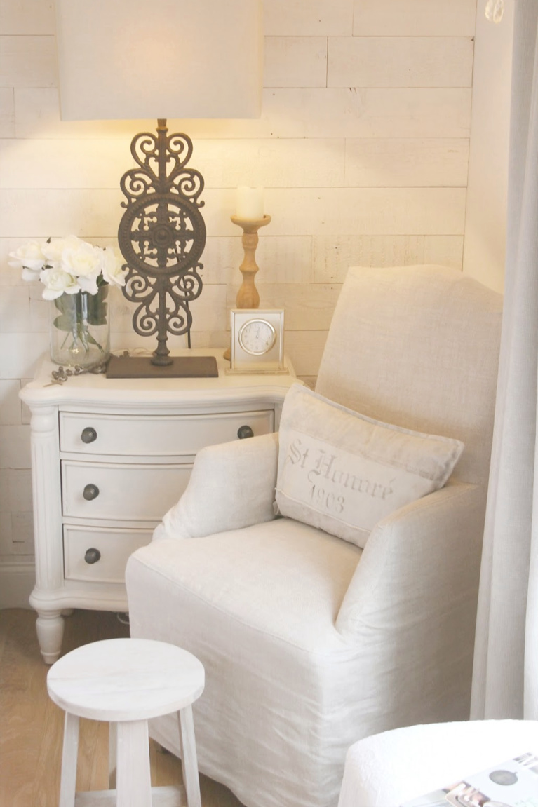 White French country cottage bedroom with Stikwood (hamptons) statement wall, white oak hardwood, and rustic alder doors. #hellolovelystudio #frenchcountry #bedroomdecor #rusticelegance #whiteoak #frenchbedrooms #alderdoor #stikwood #hamptons #romanticdecor #whitebedrooms #interiordesign