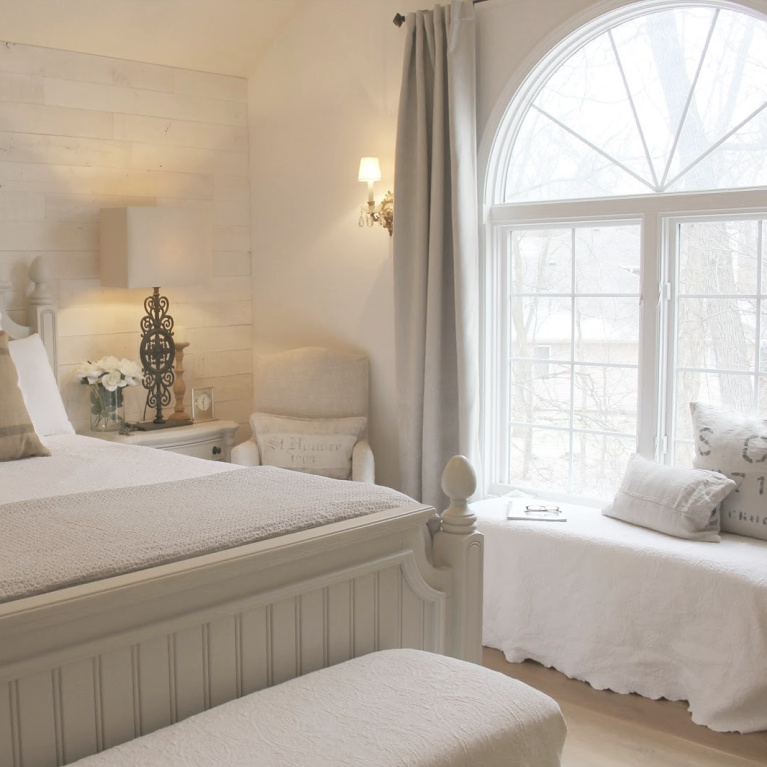 White French country cottage bedroom with Stikwood (hamptons) statement wall, white oak hardwood, and rustic alder doors. #hellolovelystudio #frenchcountry #bedroomdecor #rusticelegance #whiteoak #frenchbedrooms #alderdoor #stikwood #hamptons #romanticdecor #whitebedrooms #interiordesign