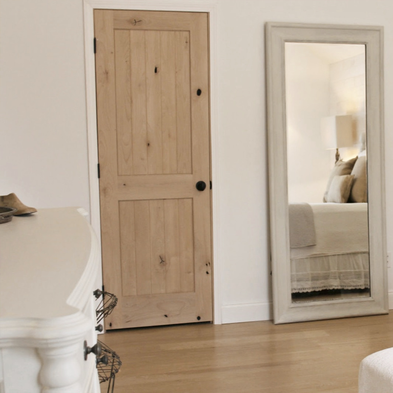 White French country cottage bedroom with Stikwood (hamptons) statement wall, white oak hardwood, and rustic alder doors. #hellolovelystudio #frenchcountry #bedroomdecor #rusticelegance #whiteoak #frenchbedrooms #alderdoor #stikwood #hamptons #romanticdecor #whitebedrooms #interiordesign