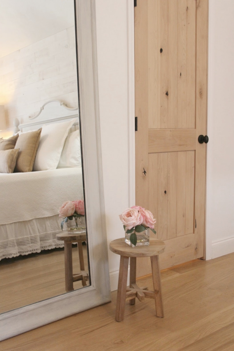 White French country cottage bedroom with Stikwood (hamptons) statement wall, white oak hardwood, and rustic alder doors. #hellolovelystudio #frenchcountry #bedroomdecor #rusticelegance #whiteoak #frenchbedrooms #alderdoor #stikwood #hamptons #romanticdecor #whitebedrooms #interiordesign