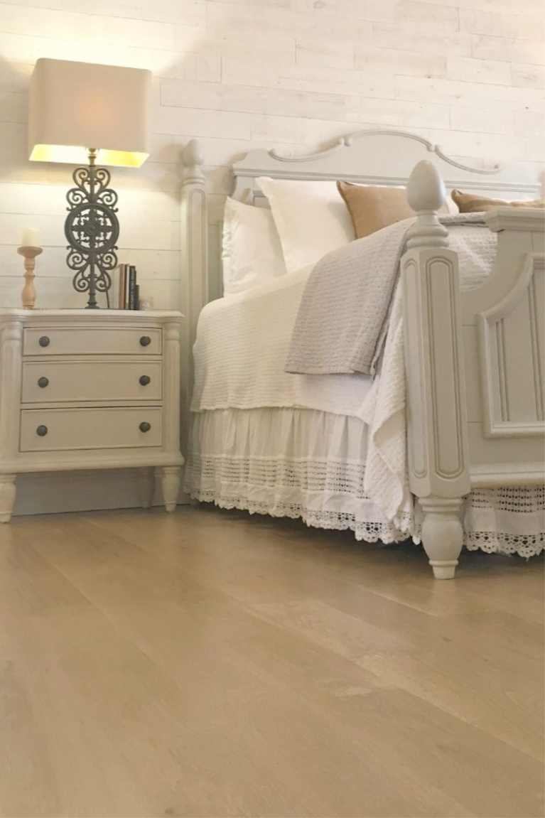 White French country cottage bedroom with Stikwood (hamptons) statement wall, white oak hardwood, and rustic alder doors. #hellolovelystudio #frenchcountry #bedroomdecor #rusticelegance #whiteoak #frenchbedrooms #alderdoor #stikwood #hamptons #romanticdecor #whitebedrooms #interiordesign