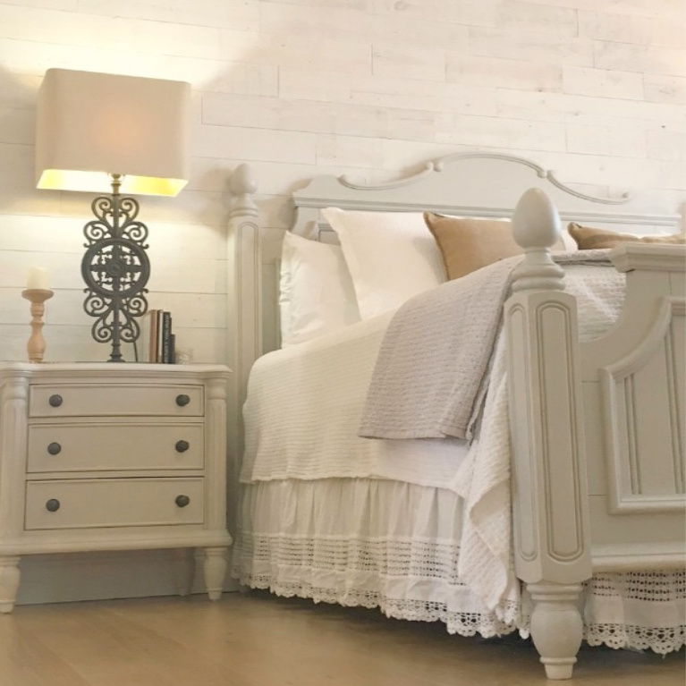 White French country cottage bedroom with Stikwood (hamptons) statement wall, white oak hardwood, and rustic alder doors. #hellolovelystudio #frenchcountry #bedroomdecor #rusticelegance #whiteoak #frenchbedrooms #alderdoor #stikwood #hamptons #romanticdecor #whitebedrooms #interiordesign