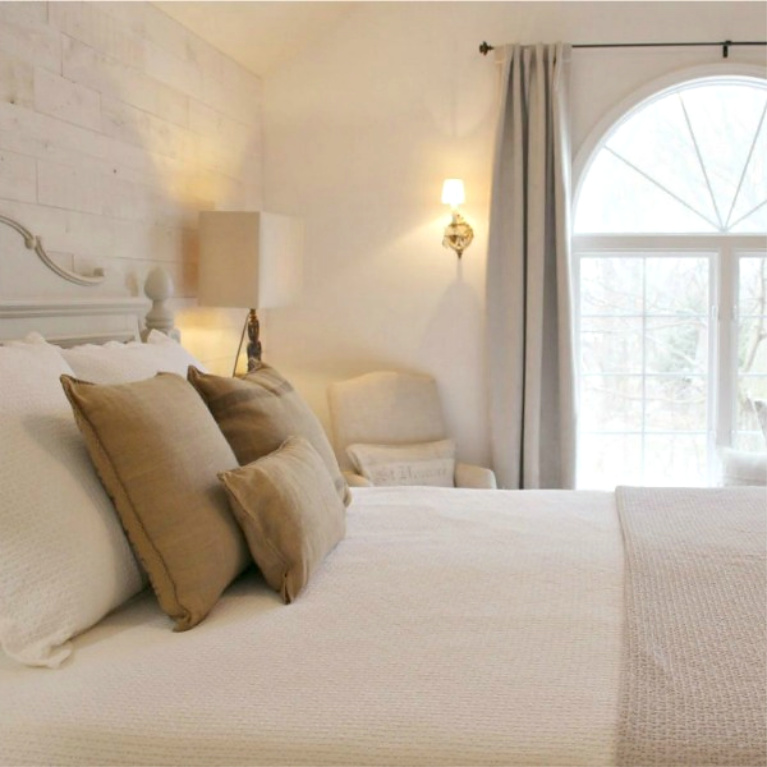 White French country cottage bedroom with Stikwood (hamptons) statement wall, white oak hardwood, and rustic alder doors. #hellolovelystudio #frenchcountry #bedroomdecor #rusticelegance #whiteoak #frenchbedrooms #alderdoor #stikwood #hamptons #romanticdecor #whitebedrooms #interiordesign