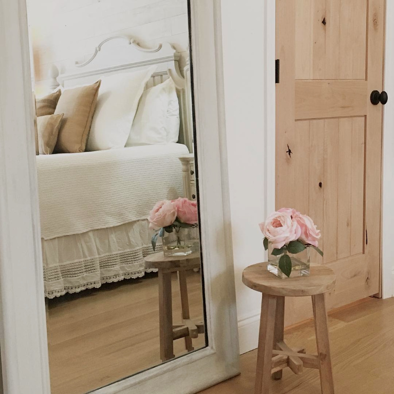 White French country cottage bedroom with Stikwood (hamptons) statement wall, white oak hardwood, and rustic alder doors. #hellolovelystudio #frenchcountry #bedroomdecor #rusticelegance #whiteoak #frenchbedrooms #alderdoor #stikwood #hamptons #romanticdecor #whitebedrooms #interiordesign