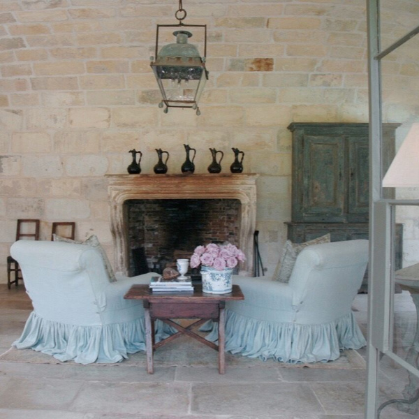 French limestone lined walls as well as European antiques in an authentically designed space in Ruth Gay's French home (Chateau Domingue). #countryfrench #frenchfarmhouse #frenchlimestone #interiordesign #oldworldstyle #chateaudomingue