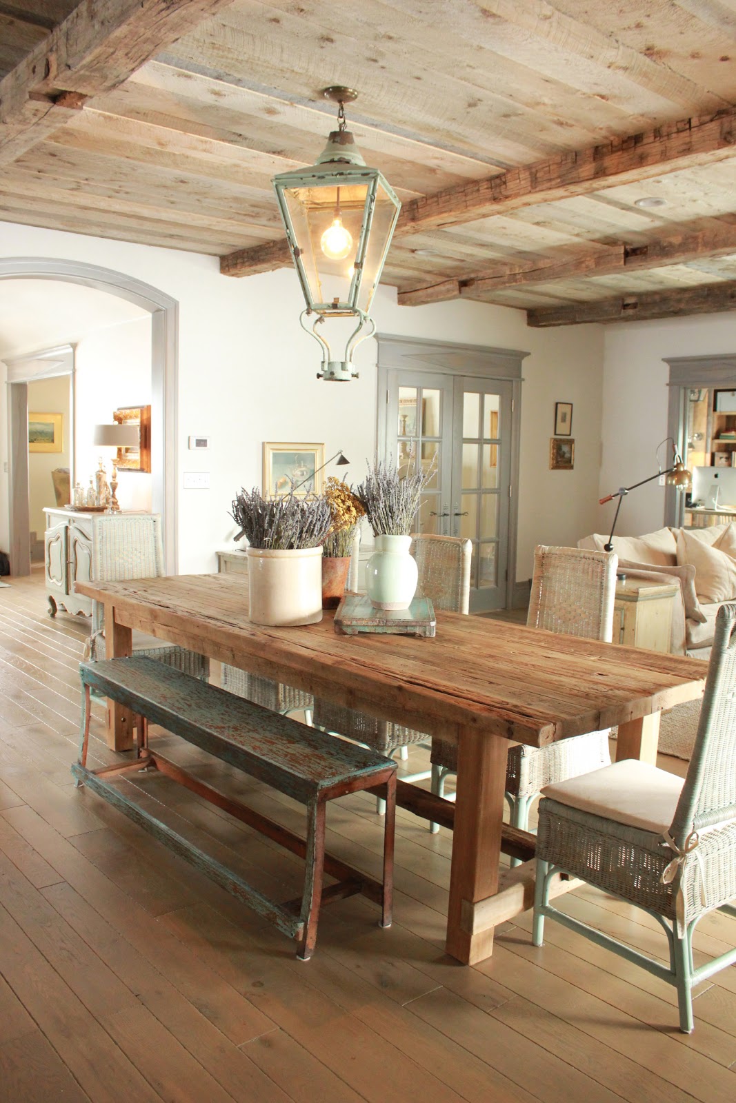 Magnificent Gustavian French dining room in stone cottage with rustic interiors, reclaimed wood ceilings, blue-grey, green, and collected European antiques. Designed by Desiree Ashworth. Find ideas for grey, blue, and green paint colors.