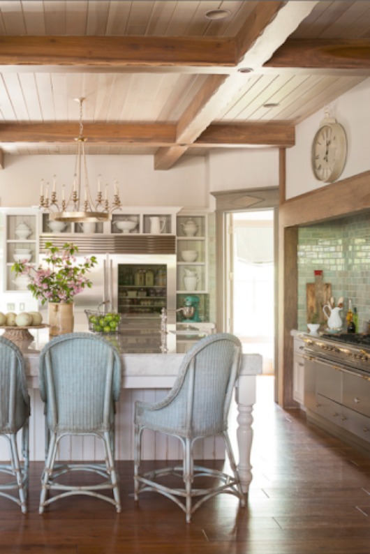 A stunning French and Gustavian inspired kitchen with wood ceiling, vintage rattan chairs at island, and aqua green accents. Decor de Provence. #FrenchCountry #Gustavian #farmhousekitchen #Frenchfarmhouse