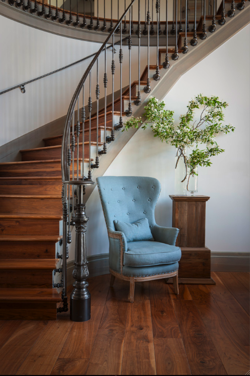 Breathtaking French inspired curving staircase with wrought iron in an exquisite French Nordic style home in Utah with interior design by Decor de Provence.
