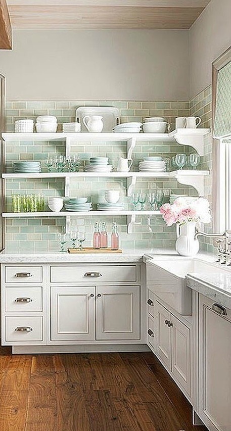 Green accents in a white French country kitchen with wood ceiling and vintage counter stools - Decor de Provence.