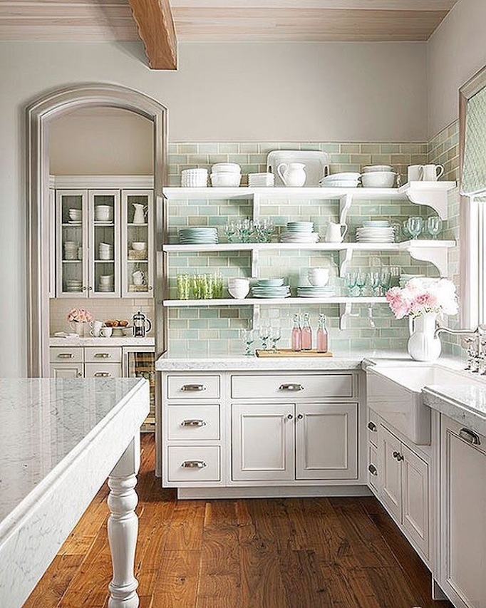 Cheerful white French Country kitchen design with soft greens and aqua blues, open shelving, and high ceilings in a stunning #FrenchCountry home by Decor de Provence. #kitchendesign #serenekitchen #Farmhousekitchen