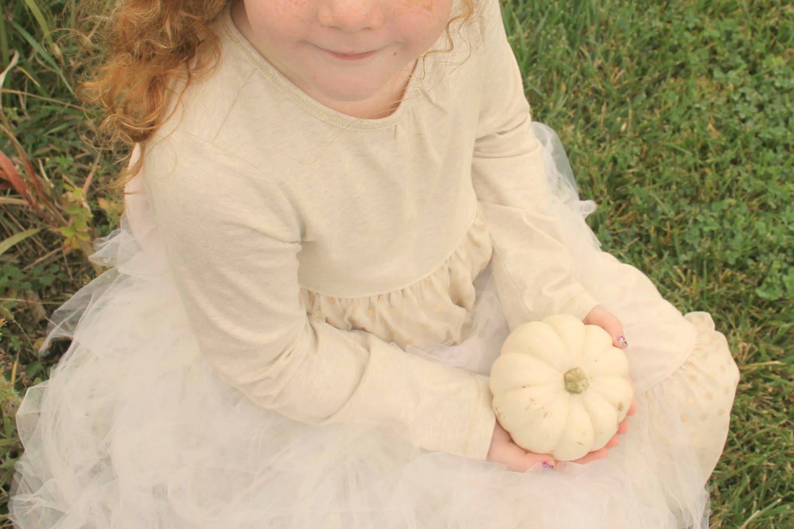 Red haired child with baby boo pumpkin by Hello Lovely Studio