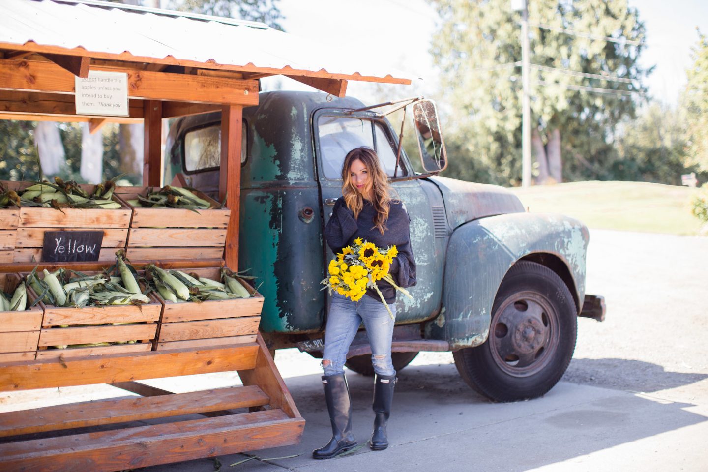 Leslie of Lemon Grove Lane with farm truck and sunflowers.