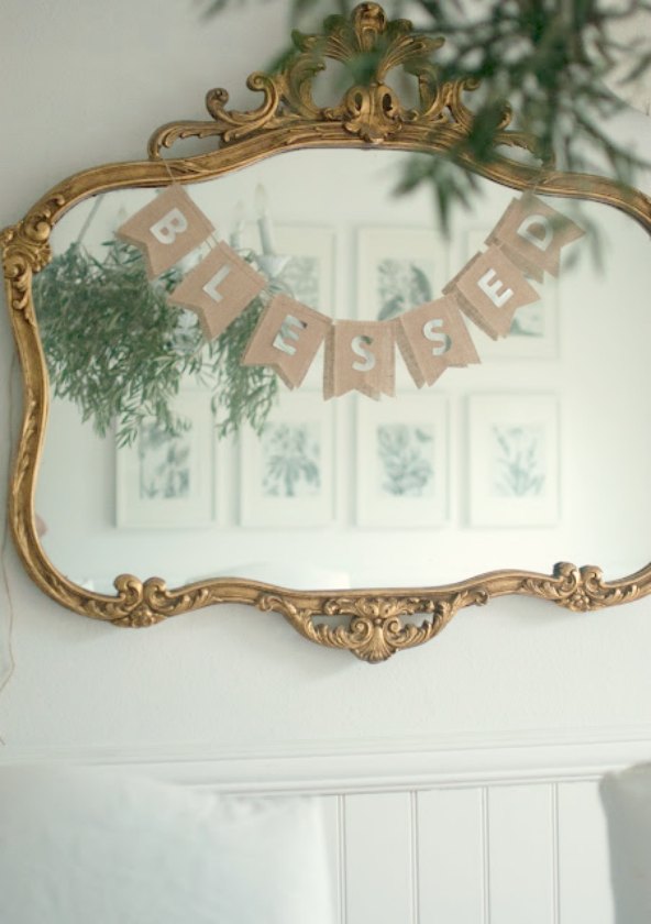 Blessed pennant banner on gilded mirror in calm dining room by Gwen Moss on Hello Lovely