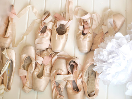 My collection of European pink dead pointe shoes in a dressing room - Hello Lovely Studio.