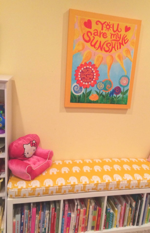Kallax Ikea Hack inspiration for a banquette or bench in a bright yellow sunshine kids room topped with a custom cushion from Hearth and Home Store. #kallaxhack #ikeahack #kallax #kallaxshelves #diy #banquette #kidsroom #bench #windowseat