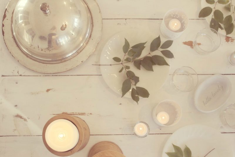 White farmhouse tablescape with silver dome platter and candlelight by Hello Lovely Studio