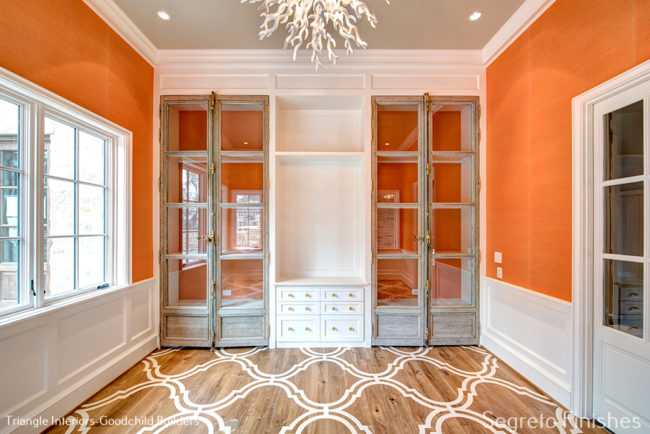 Beautiful architectural finishes in a bright orange room by Segreto Finishes
