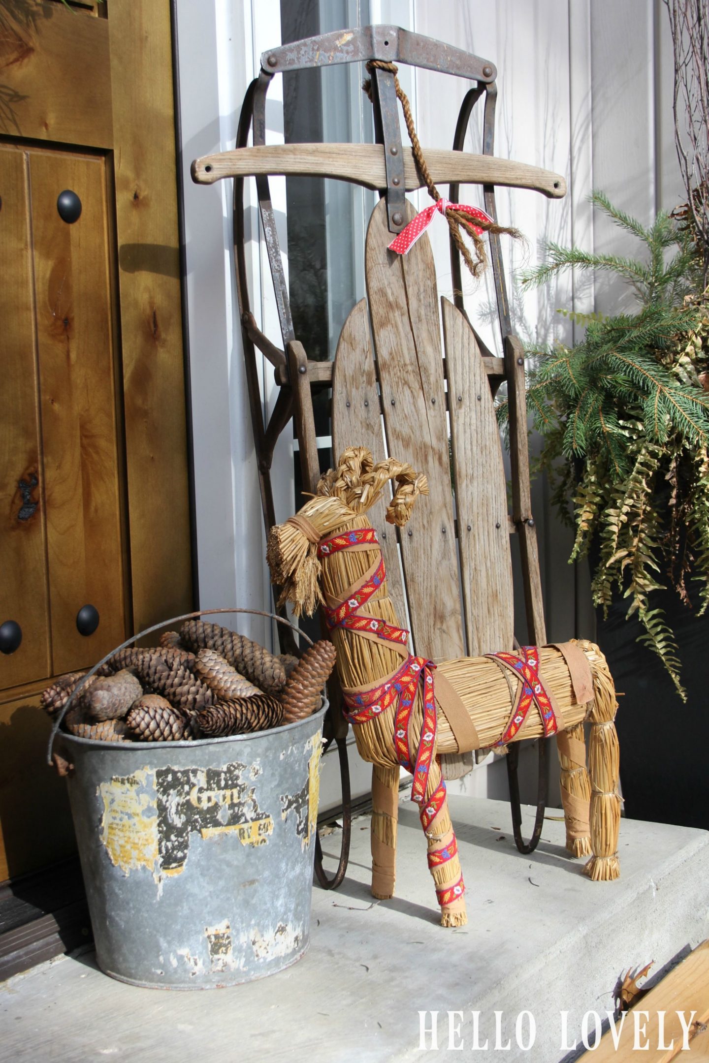 Swedish straw goat and holiday decor at my front door - Hello Lovely Studio.