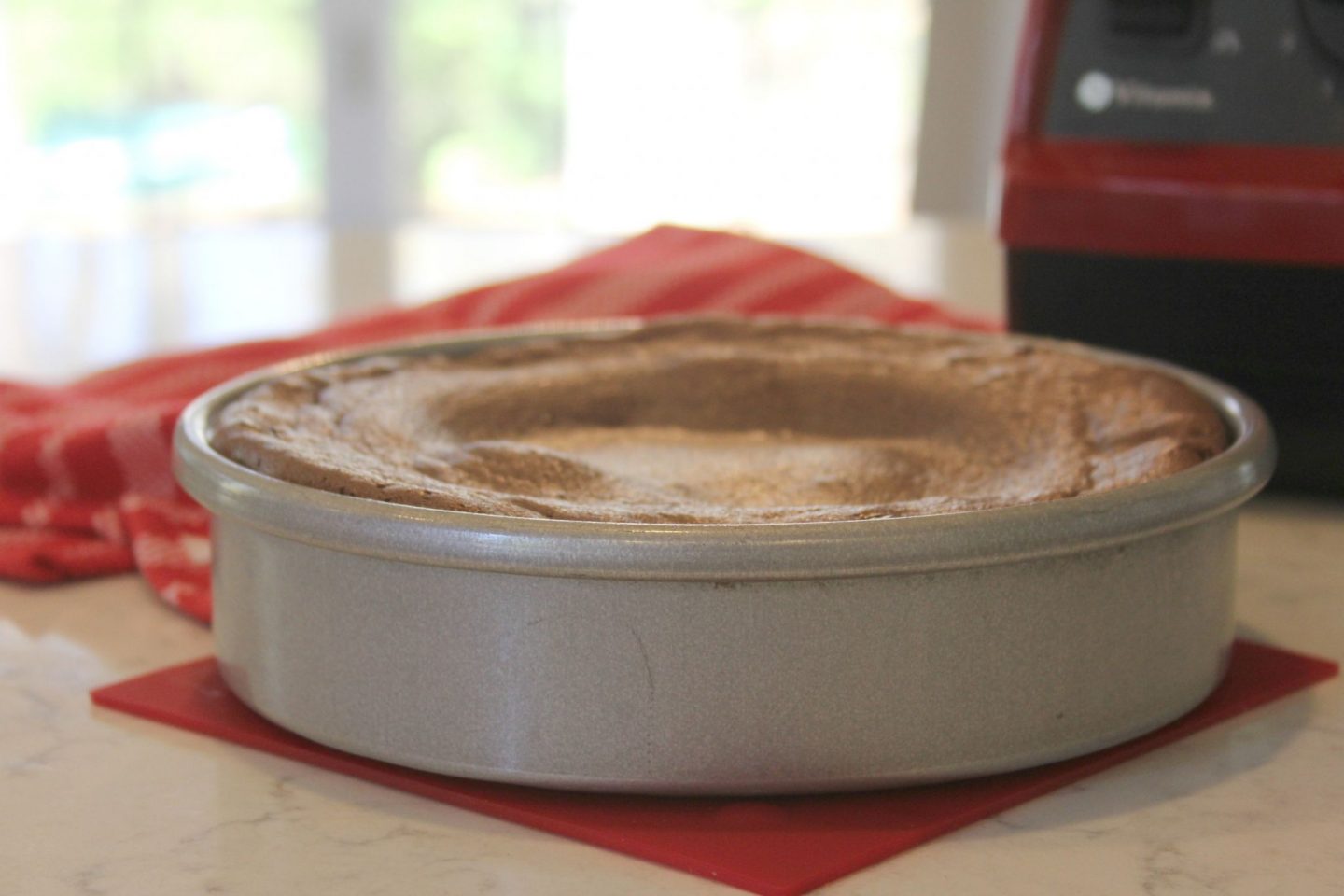 Flourless chocolate cake in pan cooling