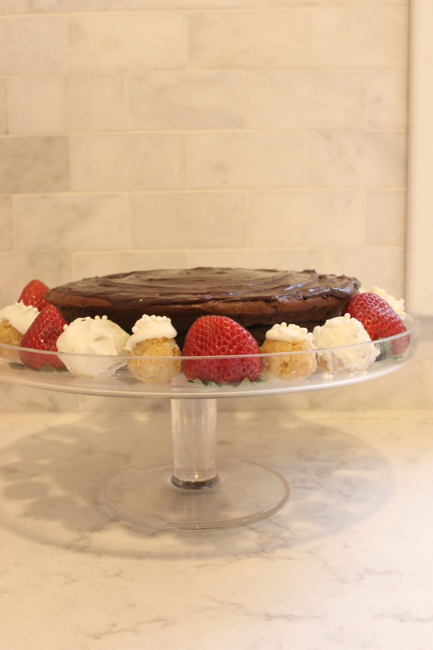 Gluten free chocolate cake with ganache, berries, and sugar cookie truffles