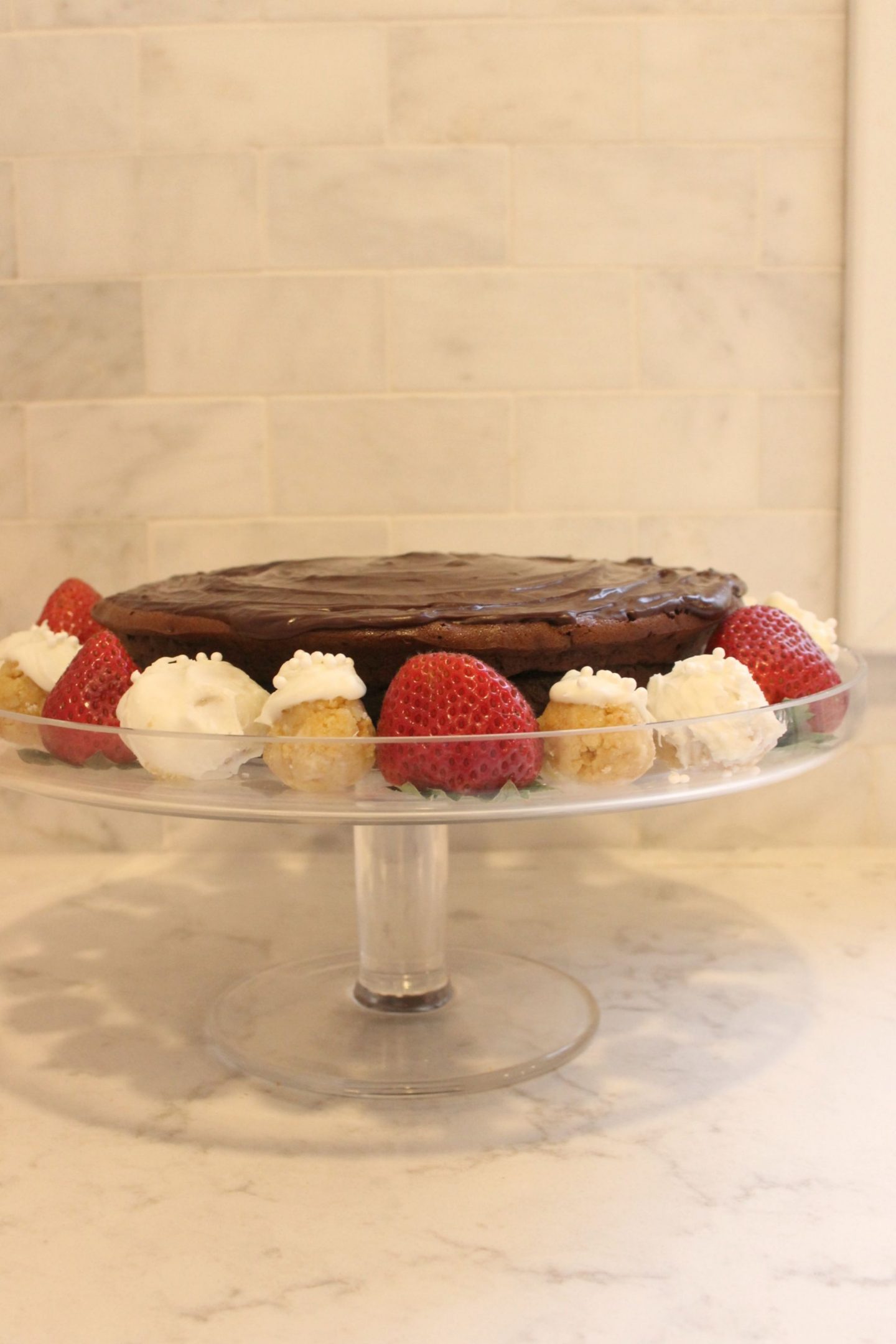 Gluten free chocolate cake with ganache, berries, and sugar cookie truffles