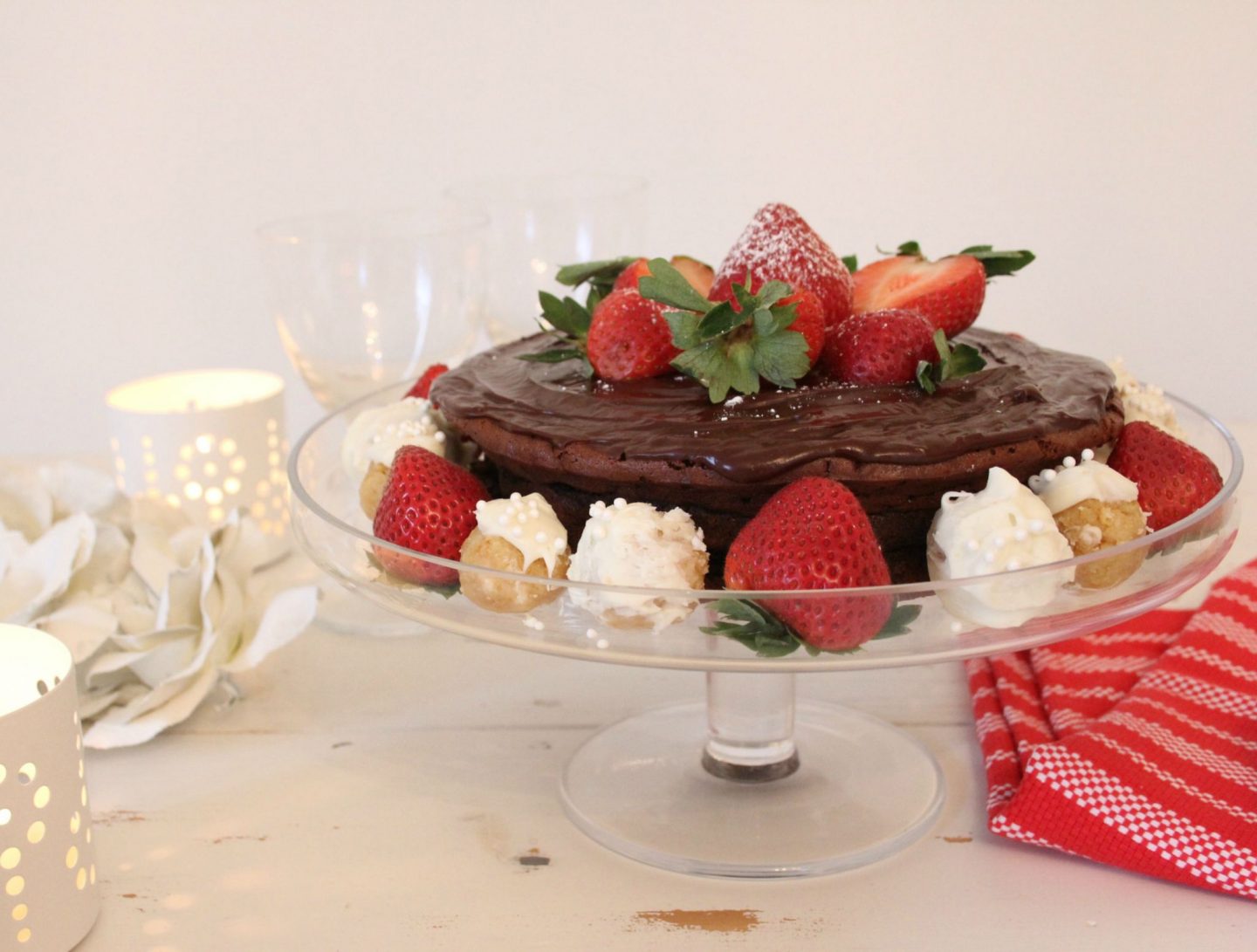 Beautiful gluten free chocolate cake decorated with berries and truffles - Hello Lovely Studio