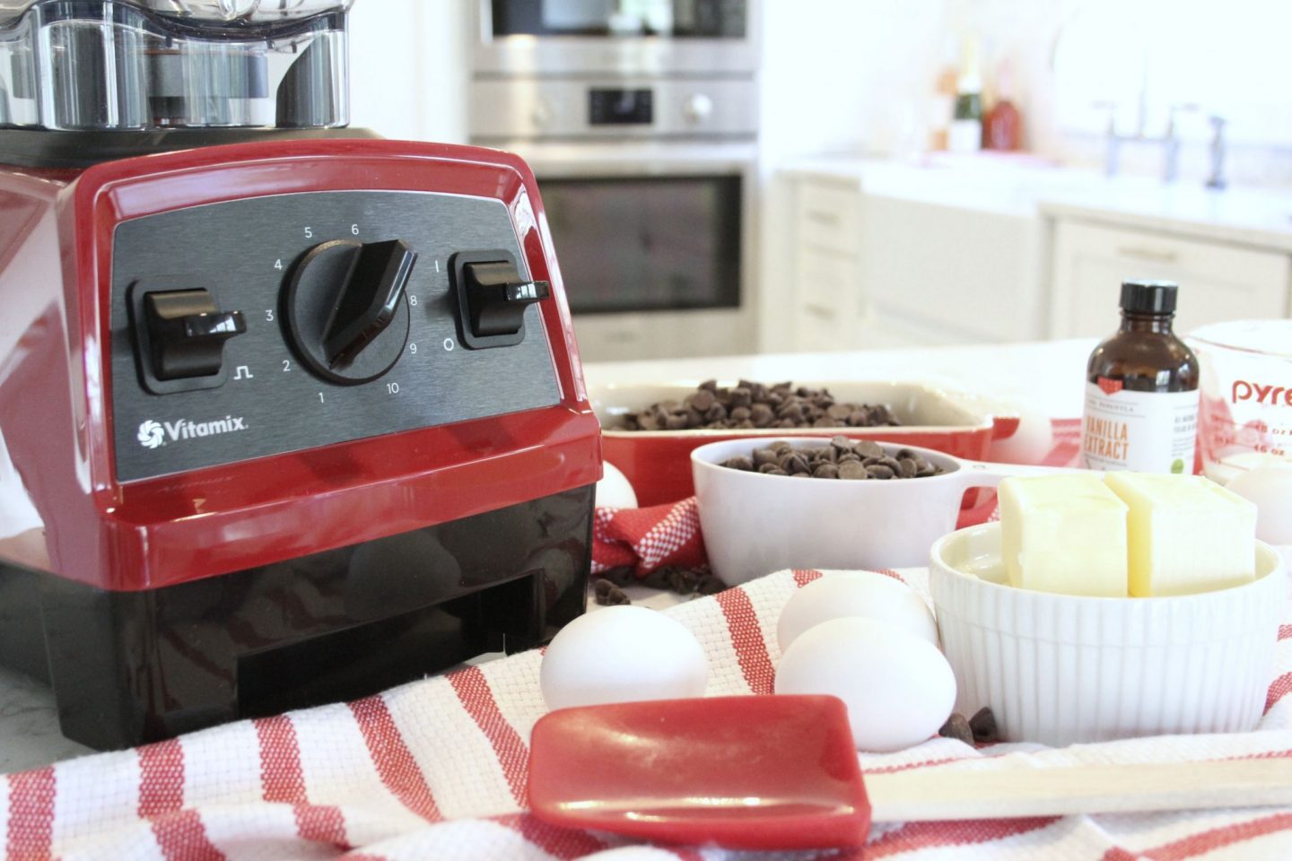 Red Vitamix Explorian E320 on counter in white kitchen - Hello Lovely Studio