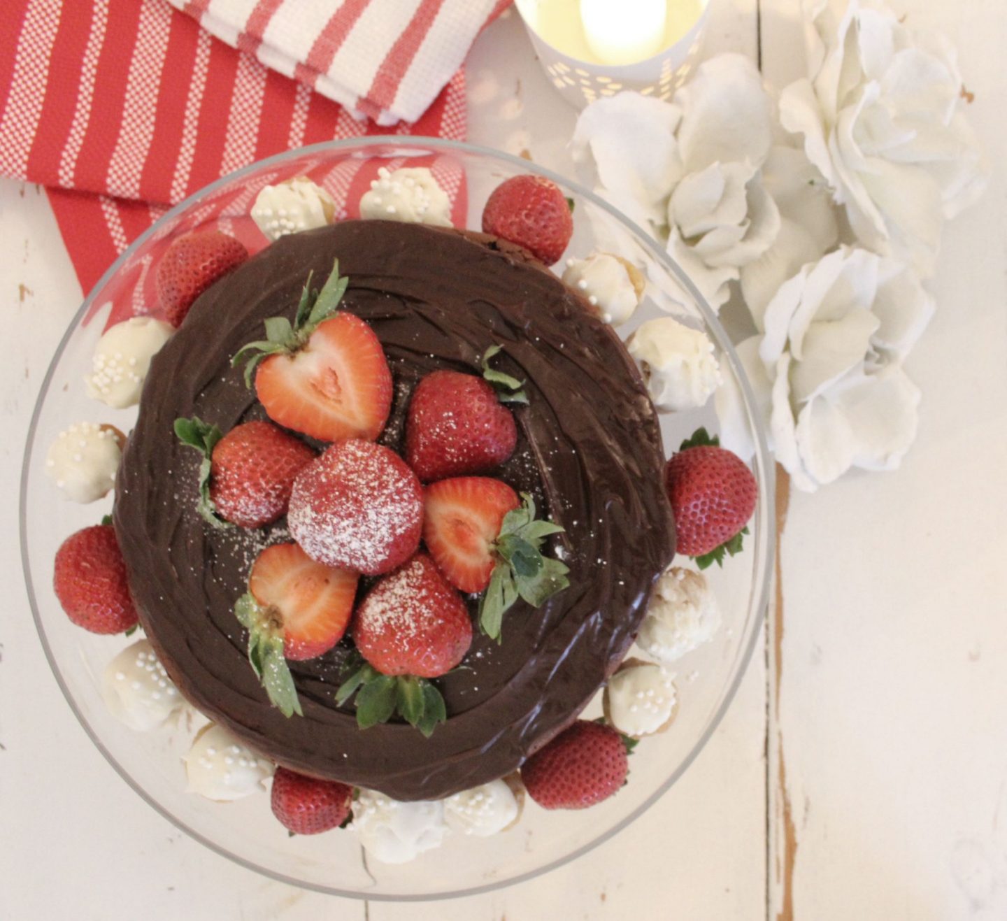 Gluten free chocolate cake topped with strawberries by Hello Lovely Studio