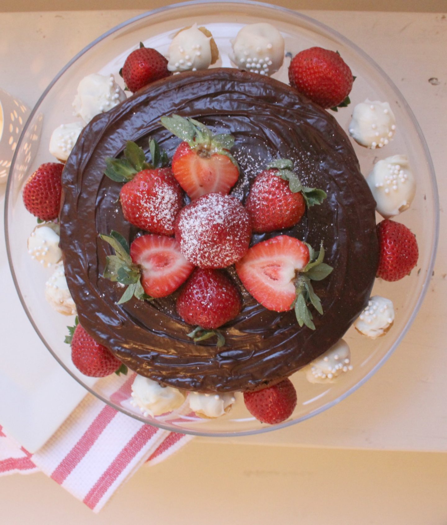 Chocolate cake with chocolate ganache, strawberries, and snowball truffles - Hello Lovely Studio