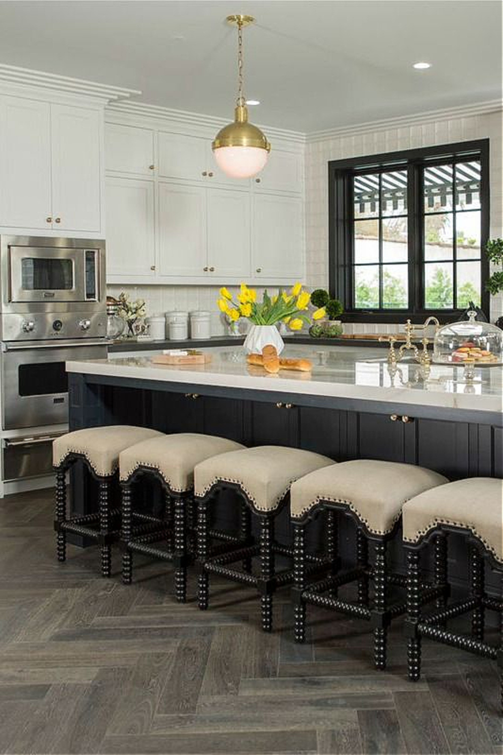 Drew's honeymoon house kitchen (a classic black and white 1920s beauty!) with Farrow & Ball Railings on island and trim. #drewscott #propertybrothers #honeymoonhouse #kitchen #railings