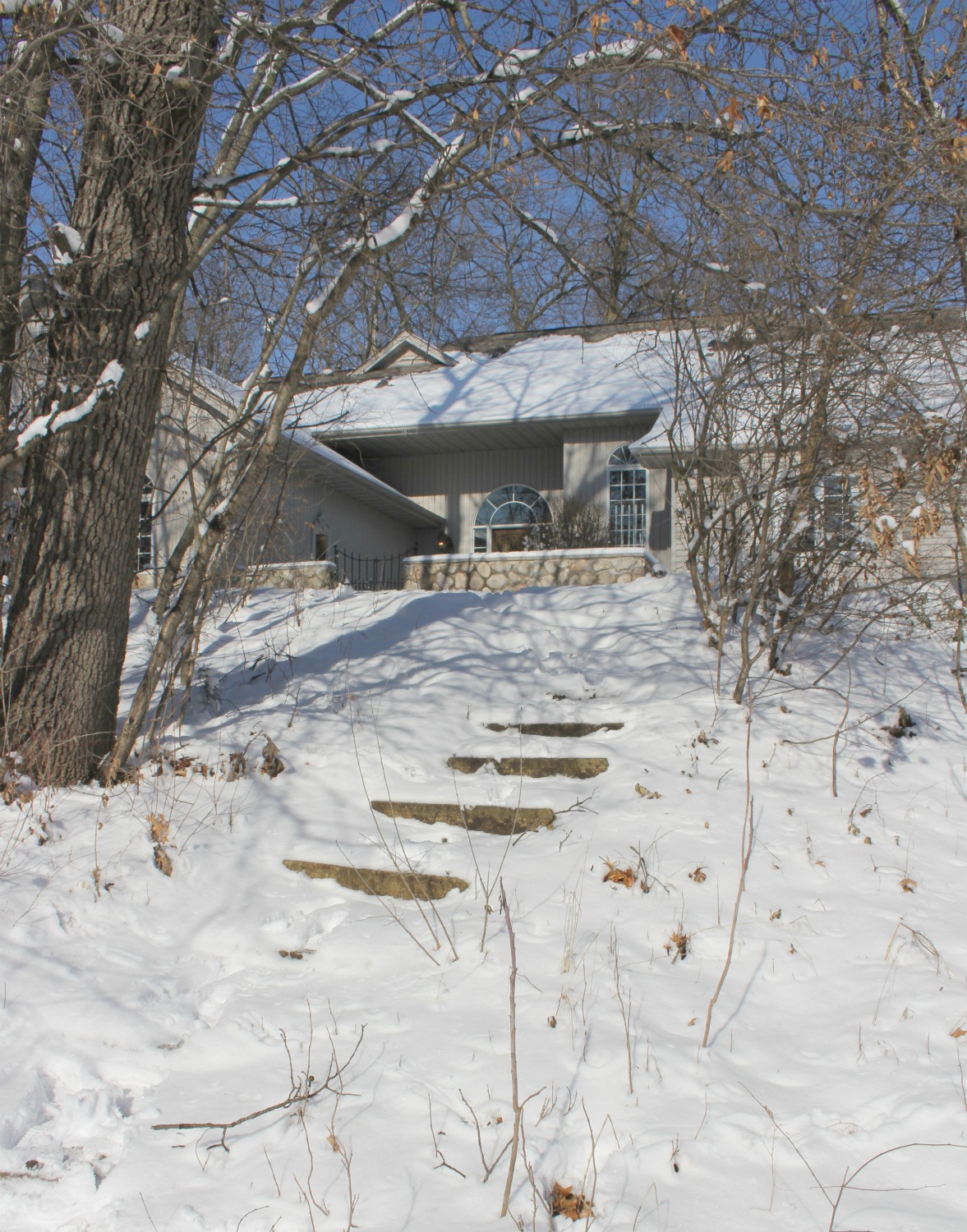 Snow covered hill in front of our home in the woods - Hello Lovely Studio.