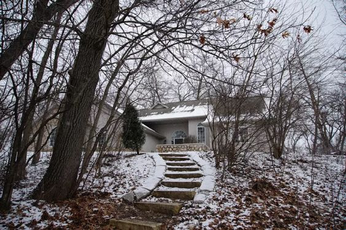 Entrance with stone steps to our home in the woods in winter - Hello Lovely Studio. #hellolovelystudio #cottageexterior