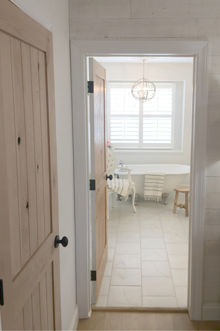 Our master bedroom and bath have rustic knotty alder interior doors and liberal doses of French country. #hellolovelystudio #bedroomdecor #alderdoors #romanticdecor #rusticelegance