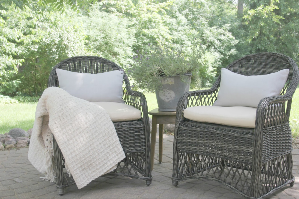 Rustic elegant patio chairs with linen pillows on my patio. #hellolovelystudio #patiochairs #rattanchairs #europeancountry #outdoordecor