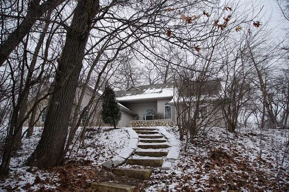 Light dusting of snow on hill in front of rustic modern cottage - Hello Lovely Studio. Come explore 7 Satisfying Highs for a Hopelessly Happy Homebody!