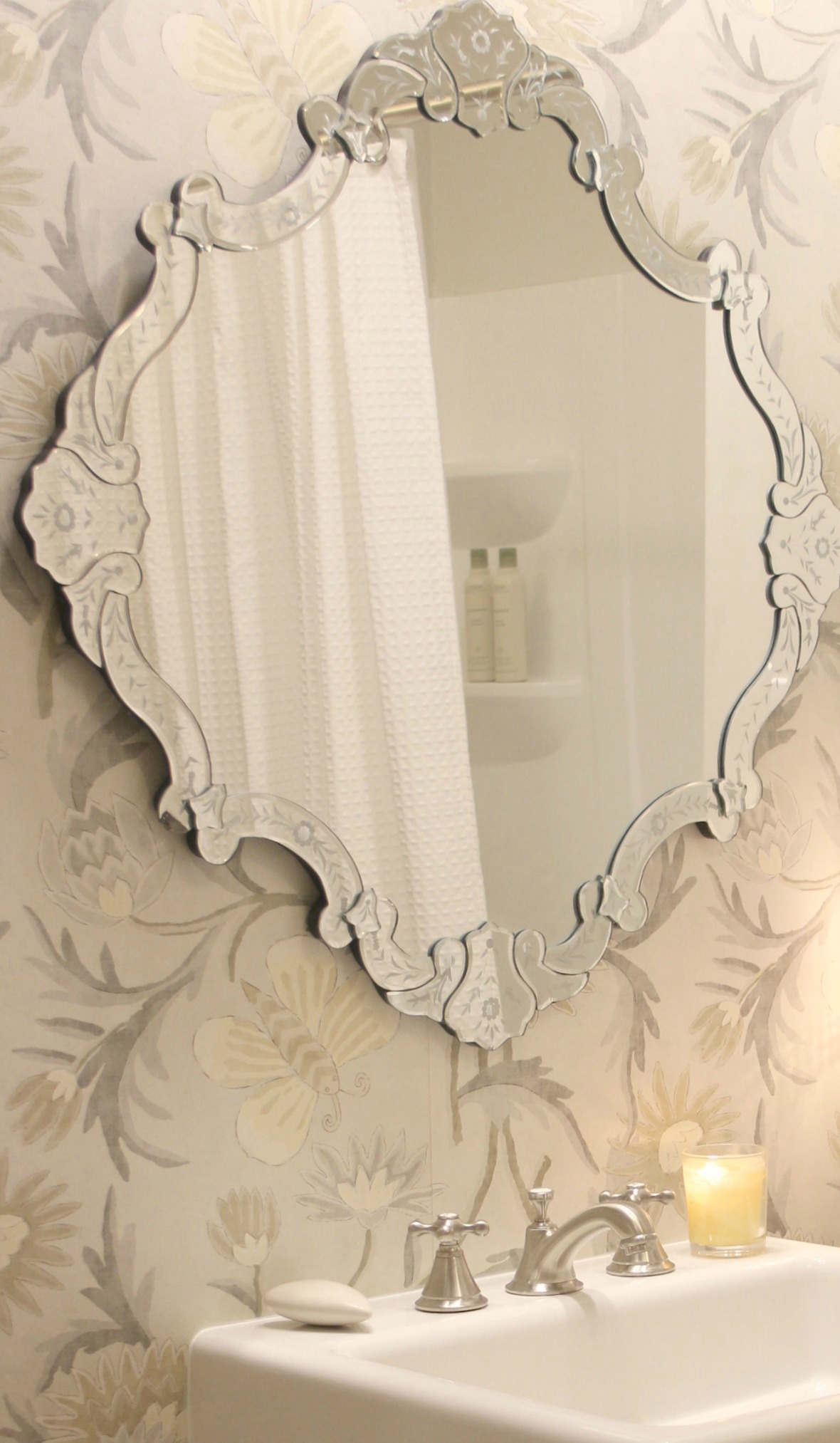 Thibaut Lizette wallpaper in Hello Lovely's bath with Venetian mirror, console sink and Grohe taps.
