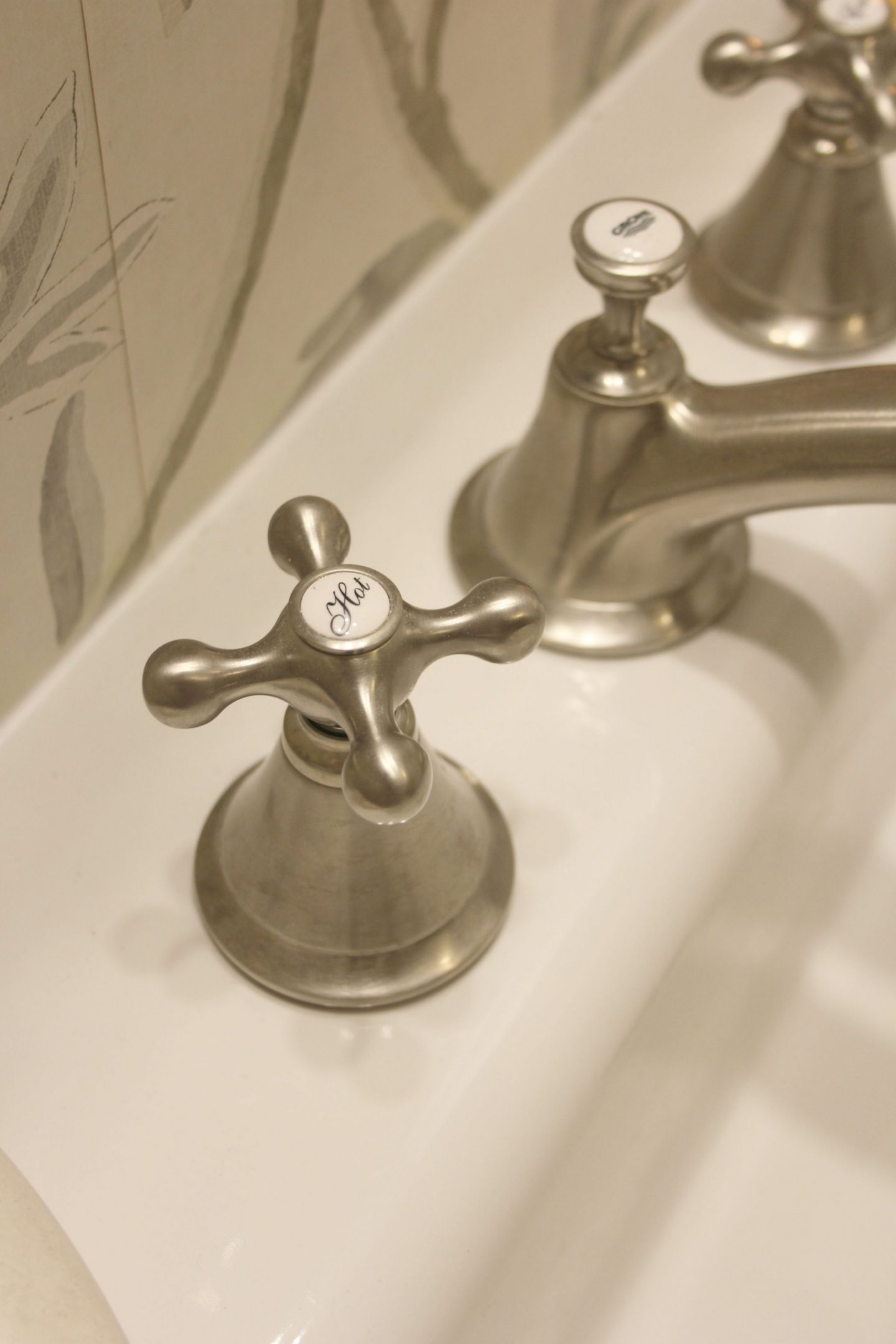 Detail of the brushed nickel widespread Seabury #bathroomfaucet by #Grohe with #crosshandles. Its classic design is perfect for a #modernfarmhouse bathroom!