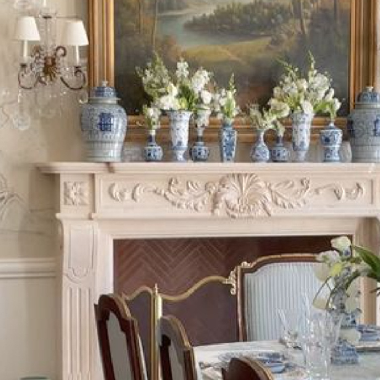 Traditional beautiful blue and white porcelain on a French fireplace mantel in Tina's dining room - The Enchanted Home.