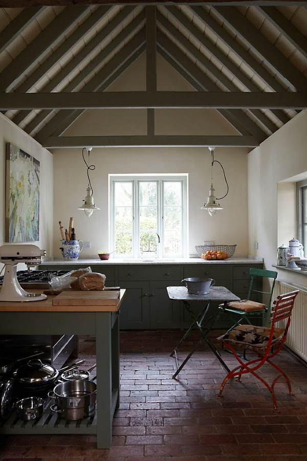 Pointing by Farrow & Ball is a paint color used on the walls of this English country kitchen with rustic ceiling trusses and farmhouse pendants. #pointing #farrowandball #paintcolors #calmpaintcolors #interiordesign