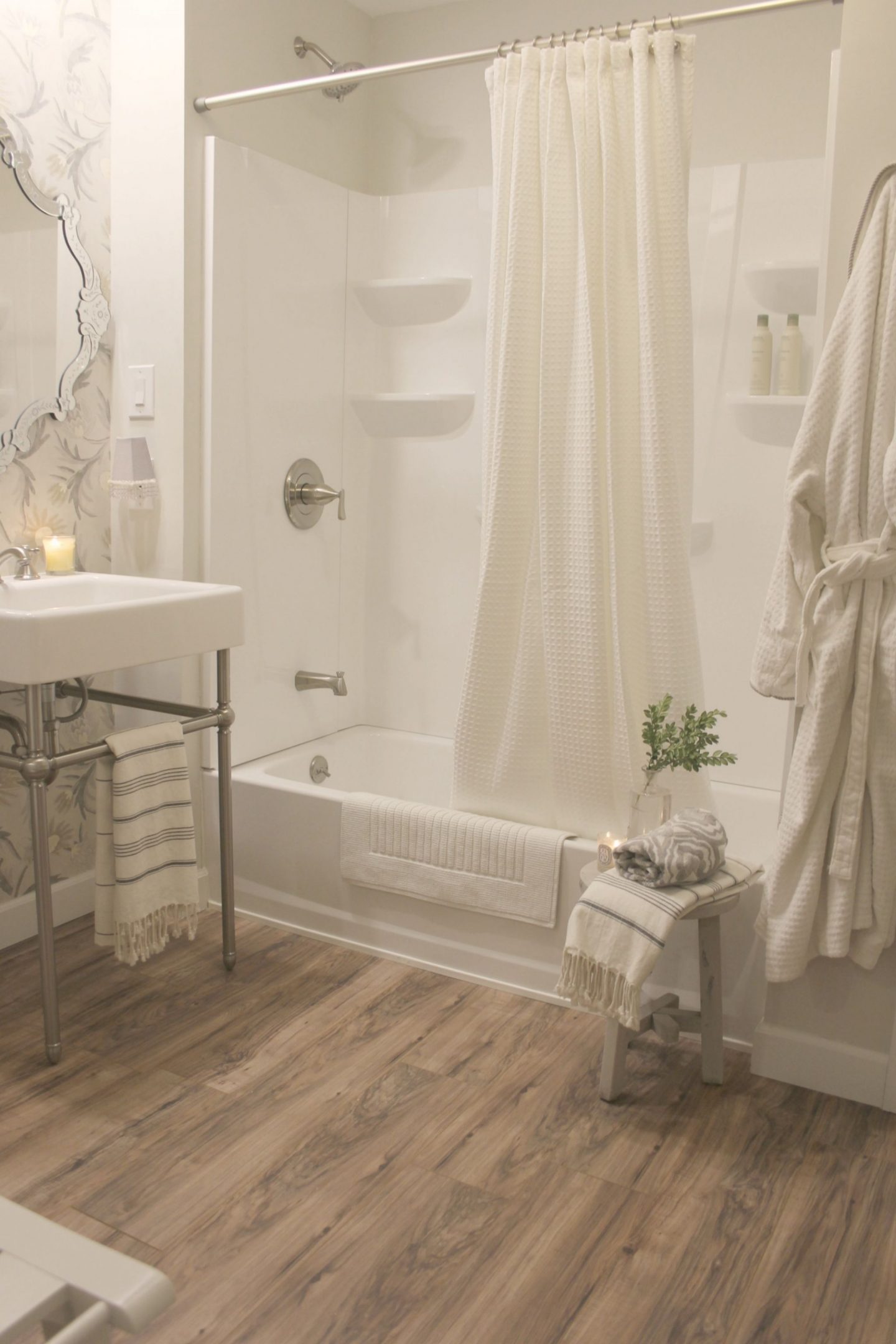 A light and bright classic bathroom we created DIY style in a dark, dreary basement. #beforeandafter #DIYbathroom #consolesink #bathroomdesign