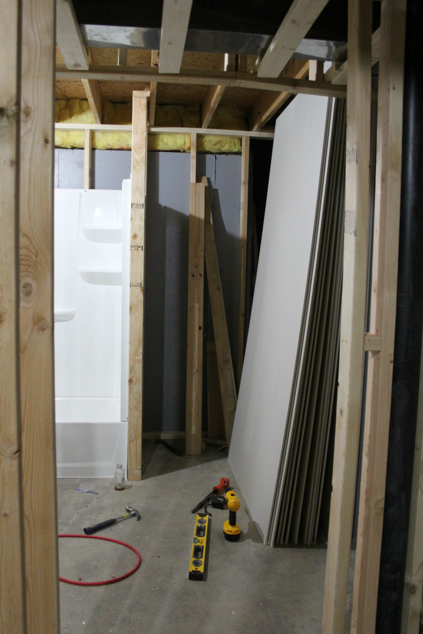 See how we added a full bathroom to our home, stealing unfinished space in the basement. #beforeandafter #renovation #bathroomdesign